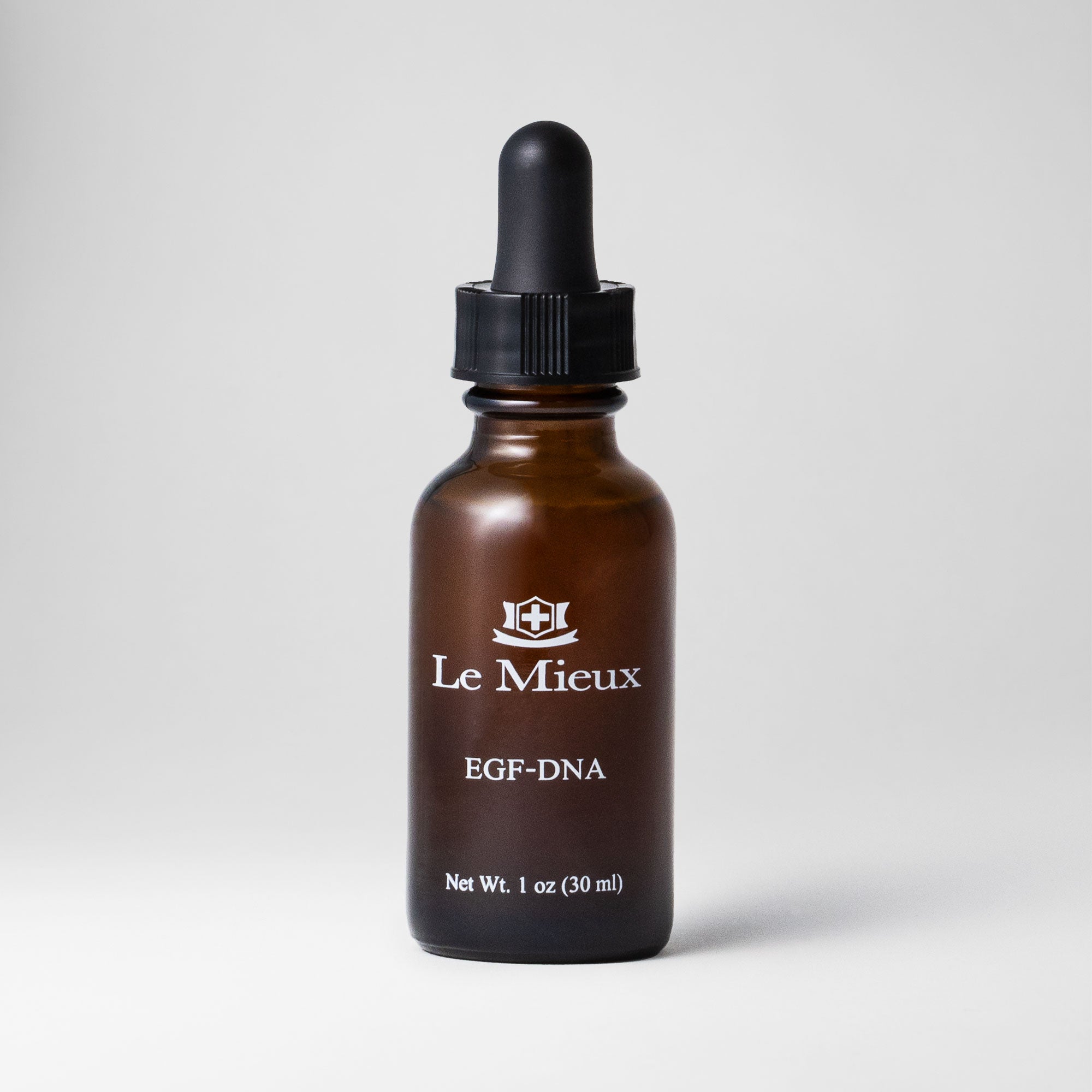 EGF-DNA 1 oz amber bottle with black dropper lid isolated on a light grey background