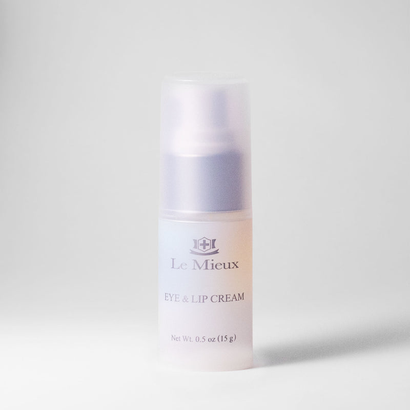 0.5 oz bottle with lid isolated in front of a light gray background. Bottle reads "Eye & Lip Cream" and has the Le Mieux logo above the product name. Soft pastel hues of blue, orange, and pink color the product.