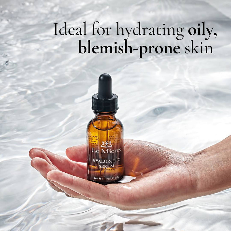 Hand holding serum bottle over water for oily skin